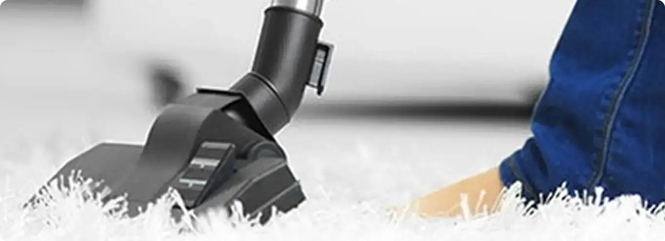 Close-up of a professional vacuuming a white carpet in Rocky River.